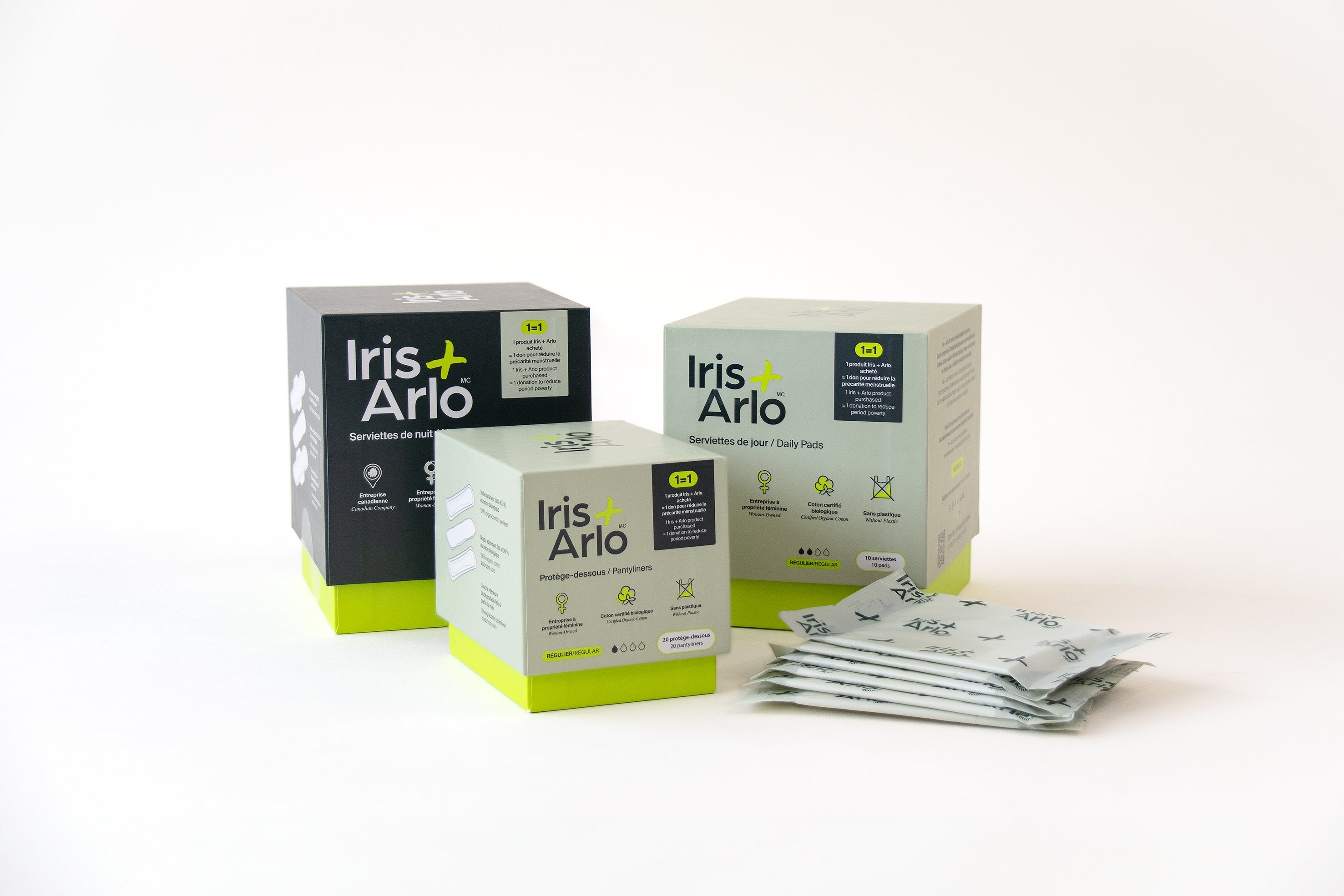 Boxes of Iris + Arlo organic daily pads staked one on top of the other