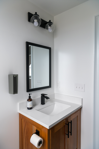 Recycled Wall-mounted Plexiglass Mural Dispenser - Pantyliners in a corporate bathroom
