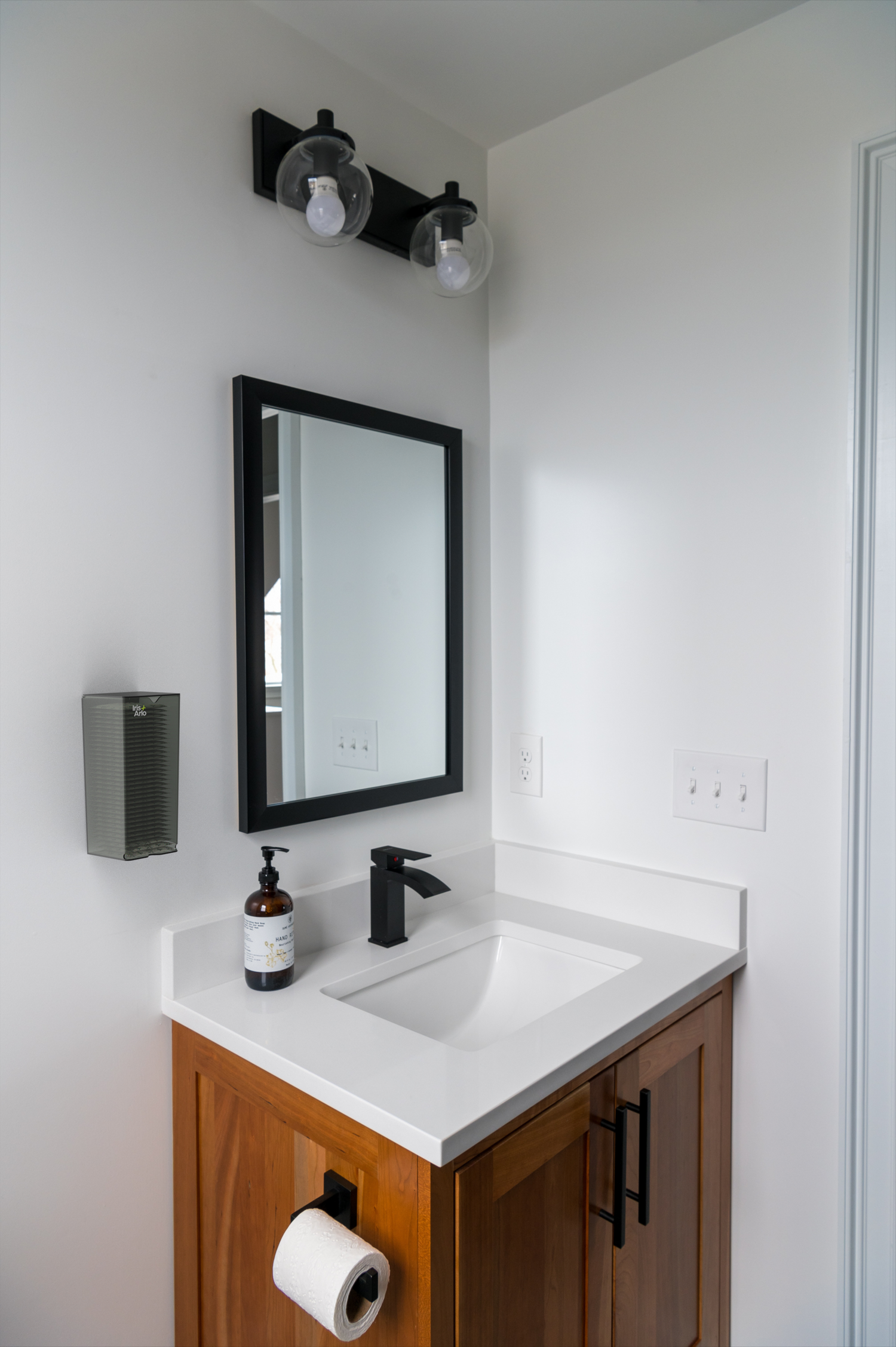 Iris + Arlo Recycled Wall-mounted Plexiglass Mural Dispenser - Daily Pads in a corporate bathroom